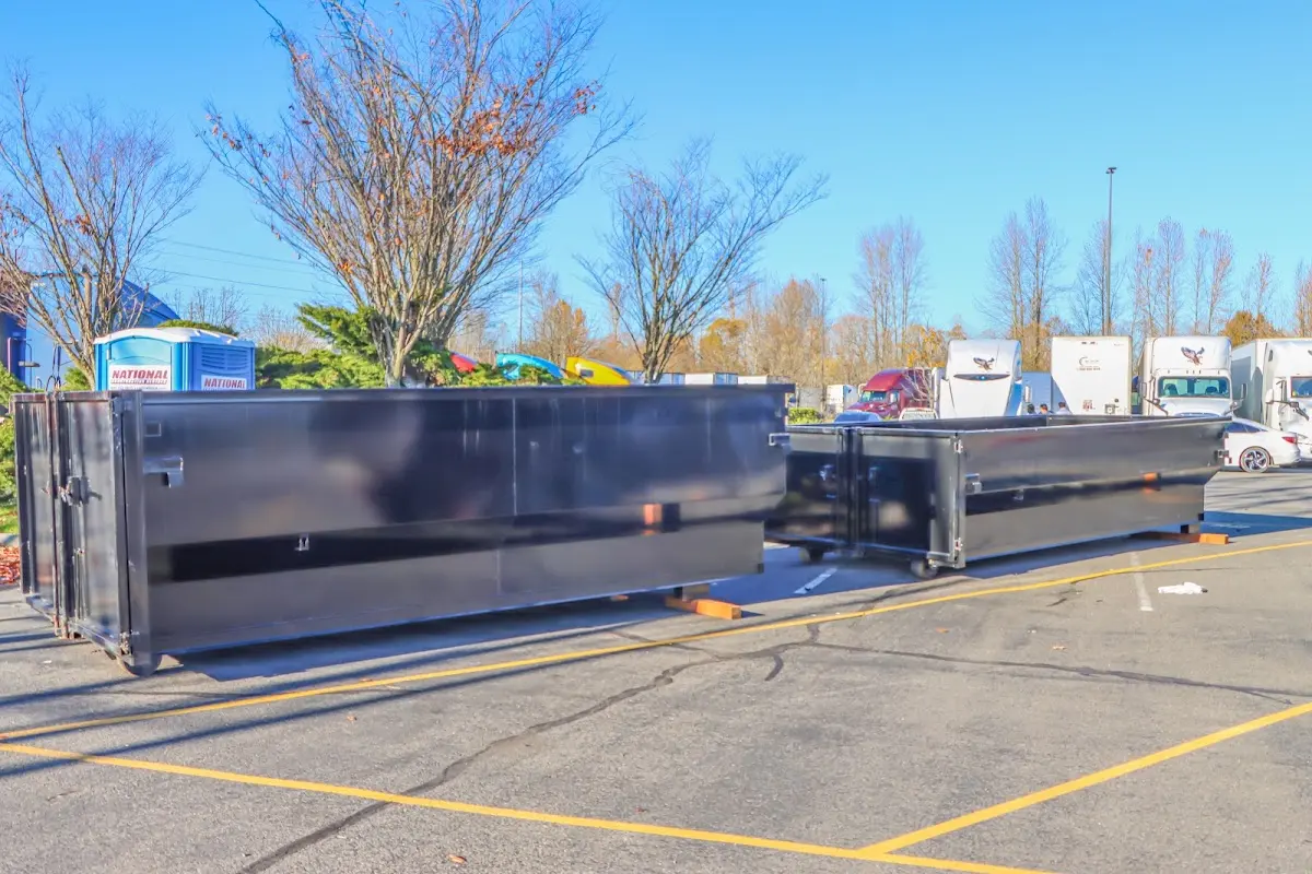 Professional dumpster rental service with roll-off container on residential driveway in Hawaiian Paradise Park